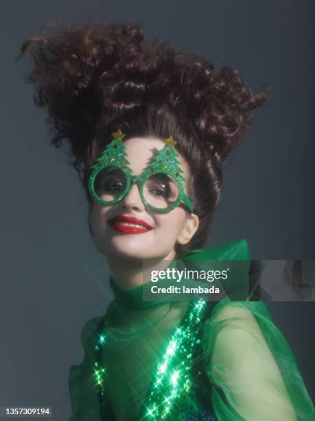 fashionable woman wearing funny christmas party glasses - sequin blouse stockfoto's en -beelden