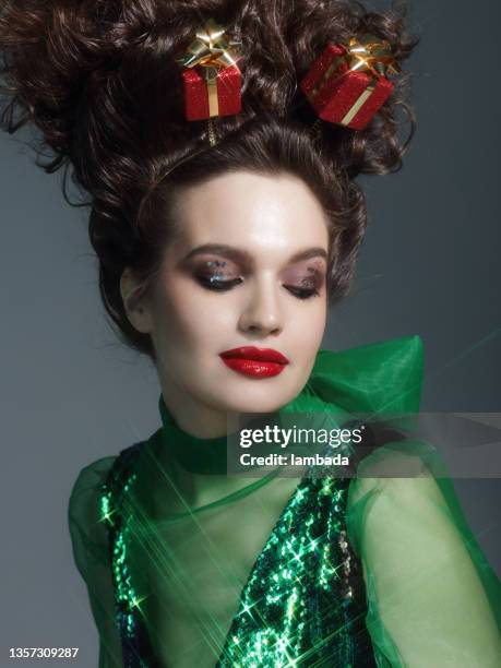 young woman wearing headband with christmas gift boxes - crazy holiday models stock pictures, royalty-free photos & images