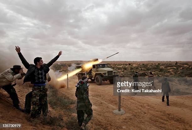 Rebel soldiers fighting against Col. Muammar Gaddafi fire a Katyusha rocket at the frontline March 9, 2011 near Ras Lanuf, Libya. The government...