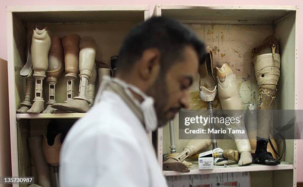 Technician works on a prosthetic at the Factory of Prosthetic Limbs on December 13, 2011 in Baghdad, Iraq. Wounded Iraqis face a shortage of the...