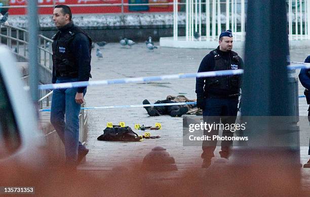 The dead body of gunman Nordine Amrani is cordoned off by police at Place St-Lambert on December 13, 2011 in Liege, Belgium. Three people were killed...