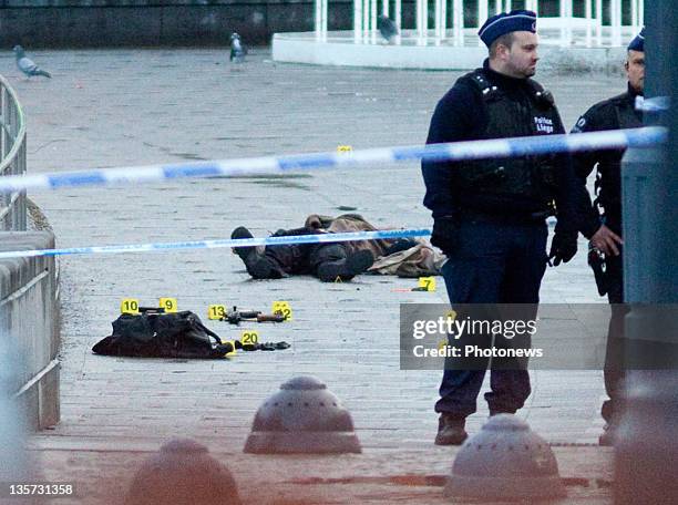 The dead body of gunman Nordine Amrani is cordoned off by police at Place St-Lambert on December 13, 2011 in Liege, Belgium. Three people were killed...