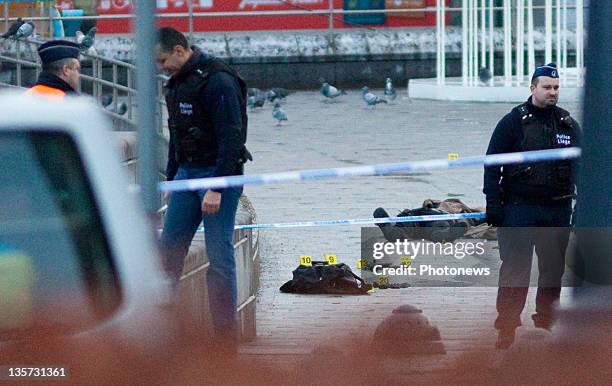The dead body of gunman Nordine Amrani is cordoned off by police at Place St-Lambert on December 13, 2011 in Liege, Belgium. Three people were killed...