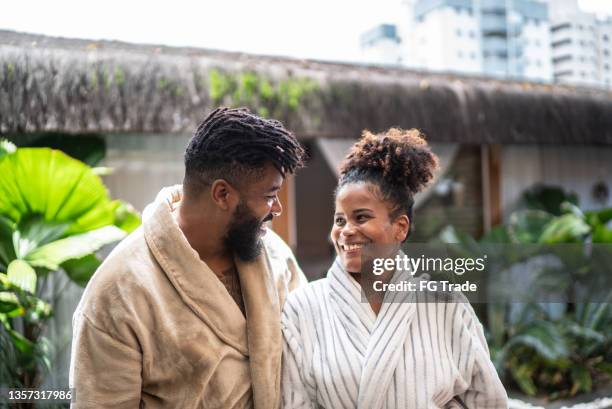 couple looking at each other at a spa - bathrobe stock pictures, royalty-free photos & images