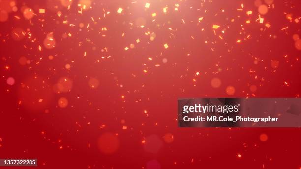 motion abstract background of glittering gold particles with lens flare, defocused gold particles on red background. christmas and celebration events  background, chinese new year background - snow festival - fotografias e filmes do acervo