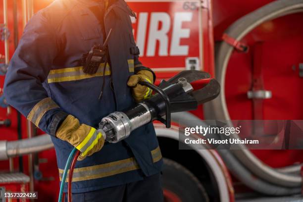 firefighter with protective uniform near fire engine. - firemen at work stock pictures, royalty-free photos & images