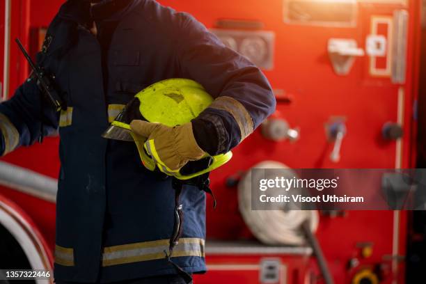 firemen preparing for emergency service. - casque de pompier photos et images de collection