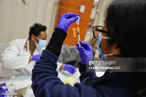 Dr. Twana Jackson prepares pediatric doses of the Pfizer COVID-19 vaccine as the Mount Sinai South Nassau Vaxmobile vists Freeport High School in...