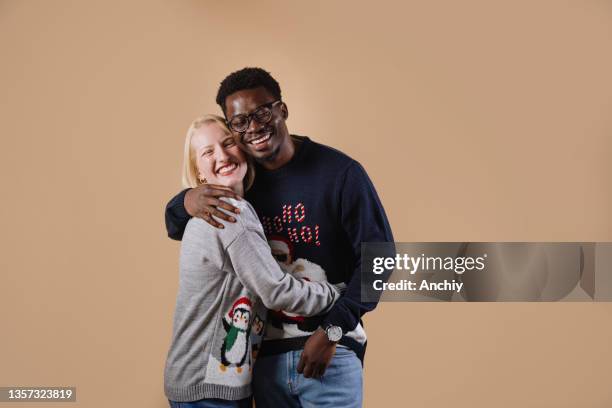 young couple wearing ugly christmas sweaters - ugly black women stock pictures, royalty-free photos & images