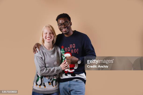 young couple wearing ugly christmas sweaters - ugly woman stock pictures, royalty-free photos & images