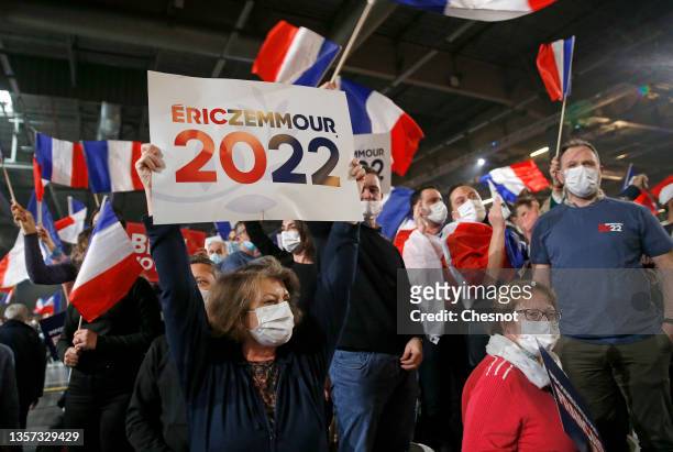 Supporter of French far right presidential candidate Eric Zemmour holds a sign 'Zemmour 2022' during his first campaign meeting on December 05, 2021...