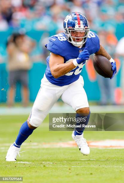Devontae Booker of the New York Giants runs with the ball against the Miami Dolphins in the first quarter at Hard Rock Stadium on December 05, 2021...