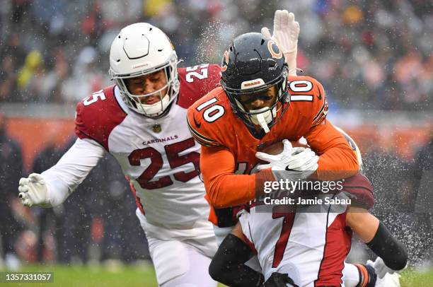 Byron Murphy Jr. #7 and Zaven Collins of the Arizona Cardinals tackle Damiere Byrd of the Chicago Bears in the first half at Soldier Field on...