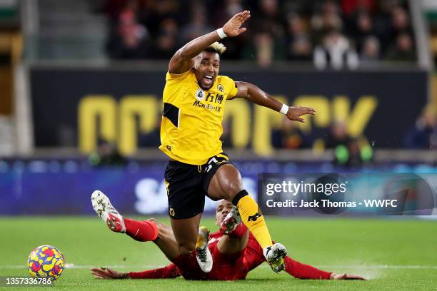 Adama Traore of Wolverhampton Wanderers is challenged by Fabinho of Liverpool during the Premier League match between Wolverhampton Wanderers and...