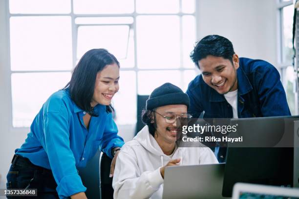 group of software developers working collaboratively - indonesian ethnicity stock pictures, royalty-free photos & images