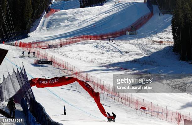 Course workers secure an inflatable finish line banner in high winds prior to the Men's Downhill during the Audi FIS Alpine Ski World Cup at Beaver...