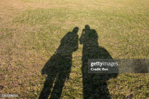 Two Men In Shadow Two People In Shadow Photos and Premium High Res Pictures - Getty Images
