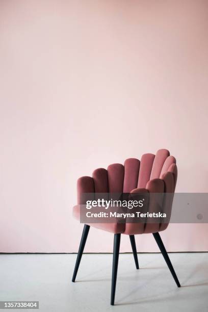 pink textured velor armchair on a pink background. - velvet couch stock pictures, royalty-free photos & images