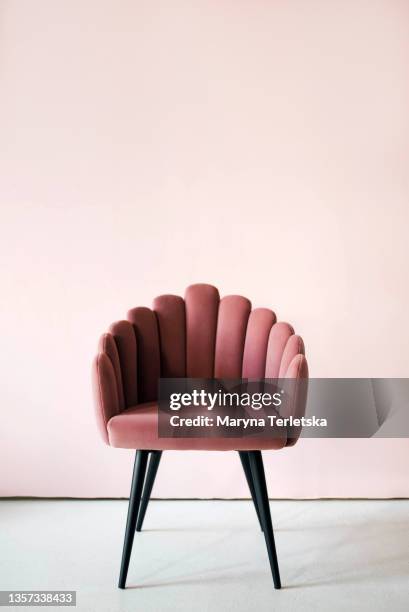 pink textured velor armchair on a pink background. - velour foto e immagini stock