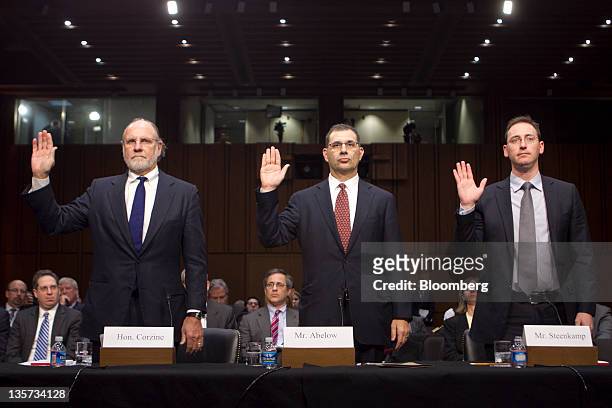 Jon S. Corzine, former chairman and chief executive officer of MF Global Holdings Ltd., left to right, Bradley Abelow, president and chief operating...