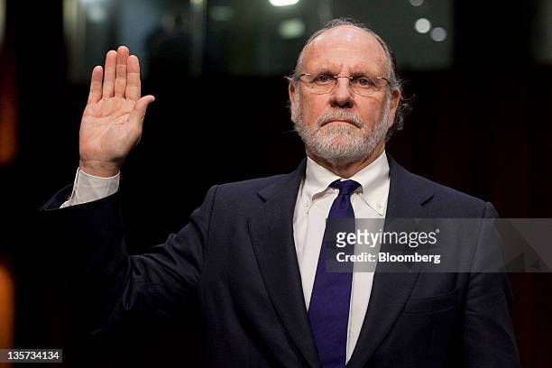 Jon S. Corzine, former chairman and chief executive officer of MF Global Holdings Ltd., is sworn in at a Senate Agriculture Committee hearing in...