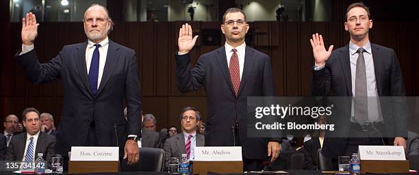 Jon S. Corzine, former chairman and chief executive officer of MF Global Holdings Ltd., left to right, Bradley Abelow, president and chief operating...