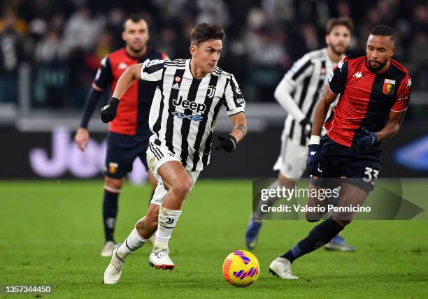 Paulo Dybala of Juventus is put under pressure by Hernani of Genoa during the Serie A match between Juventus and Genoa CFC at on December 05, 2021 in...