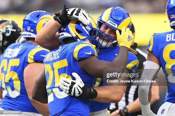 Sony Michel of the Los Angeles Rams celebrates his touchdown with Kendall Blanton during the first quarter against the Jacksonville Jaguars at SoFi...