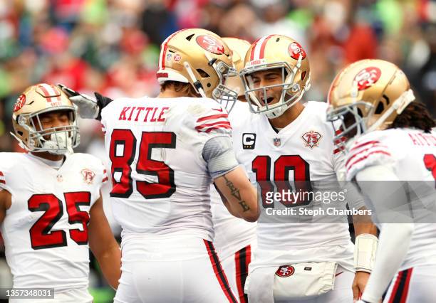 George Kittle of the San Francisco 49ers celebrates with Jimmy Garoppolo after catching the ball for a touchdown during the first quarter against the...