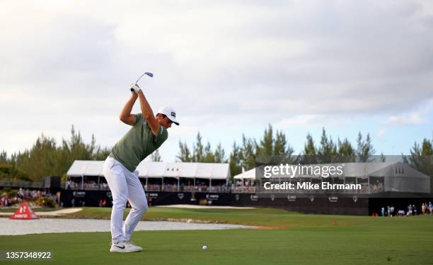 Viktor Hovland of Norway hits his approach shot on the 18th hole during the final round of the Hero World Challenge at Albany Golf Course on December...