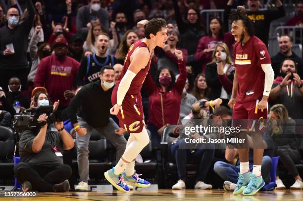 Cedi Osman and Darius Garland of the Cleveland Cavaliers celebrate after Osman scores during the fourth quarter against the Utah Jazz at Rocket...