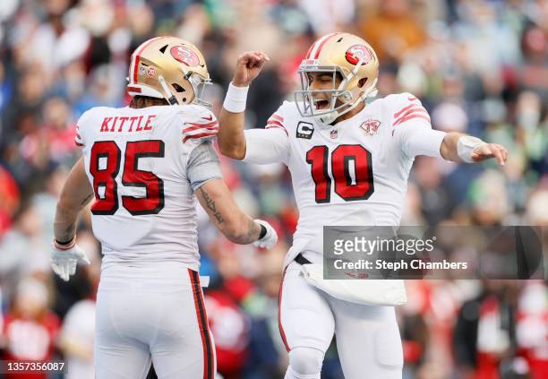 Jimmy Garoppolo of the San Francisco 49ers celebrates after throwing a touchdown pass to George Kittle during the second quarter against the Seattle...