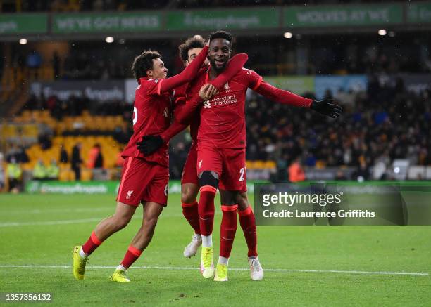 Divock Origi of Liverpool celebrates with Trent Alexander-Arnold and Mohamed Salah after scoring their side's first goalduring the Premier League...