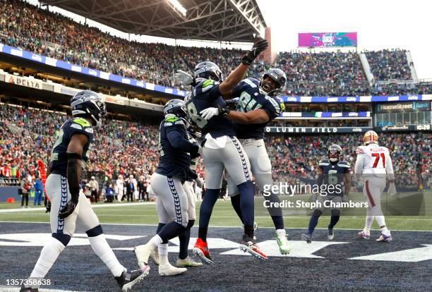 Carlos Dunlap of the Seattle Seahawks celebrates with teammates after tackling Jimmy Garoppolo of the San Francisco 49ers in the endzone for a safety...