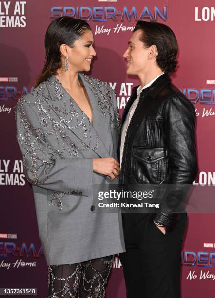 Zendaya and Tom Holland attend a photocall for "Spiderman: No Way Home" at The Old Sessions House on December 05, 2021 in London, England.
