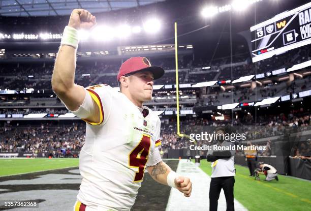 Taylor Heinicke of the Washington Football Team hods up his fist as he jogs off the field after the game against the Las Vegas Raiders at Allegiant...