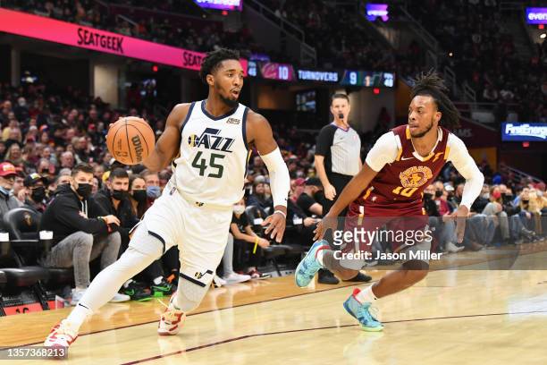 Donovan Mitchell of the Utah Jazz drives to the basket around Darius Garland of the Cleveland Cavaliers during the third quarter at Rocket Mortgage...