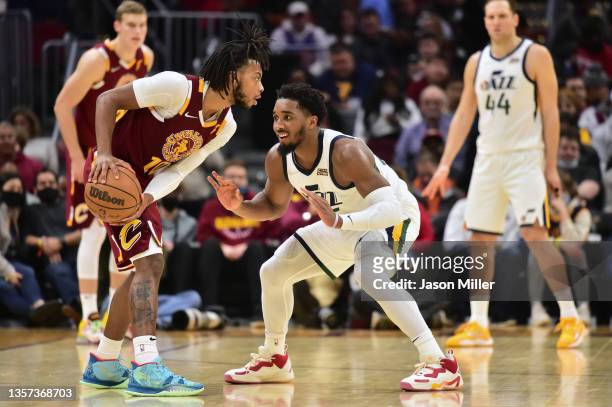 Donovan Mitchell of the Utah Jazz guards Darius Garland of the Cleveland Cavaliers d3q at Rocket Mortgage Fieldhouse on December 05, 2021 in...