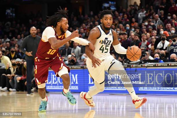 Donovan Mitchell of the Utah Jazz drives to the basket around Darius Garland of the Cleveland Cavaliers during the fourth quarter at Rocket Mortgage...