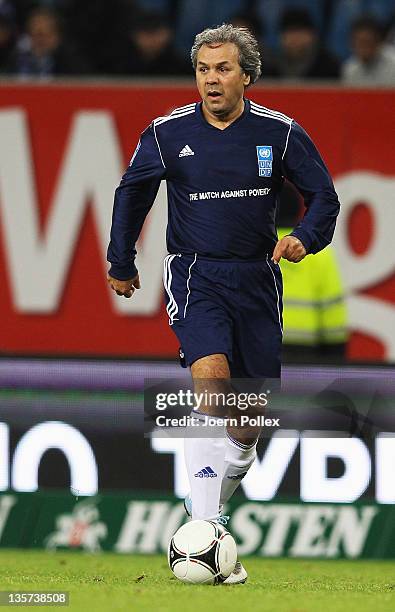 Rabah Madjer of the team Ronaldo, Zidane & Friends controls the ball during the 'Match Against Poverty' match at Imtech Arena on December 13, 2011 in...