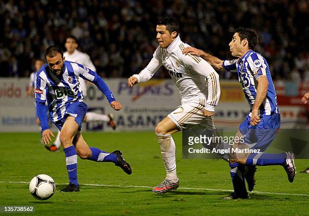 Cristiano Ronaldo of Real Madrid is challenged by David Malo of Ponferradina during the round of last 16 Copa del Rey first leg match between...