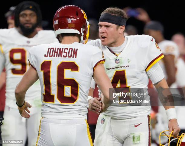 Kicker Brian Johnson of the Washington Football Team is congratulated by his teammate, quarterback Taylor Heinicke, after Johnson kicked a 48-yard...