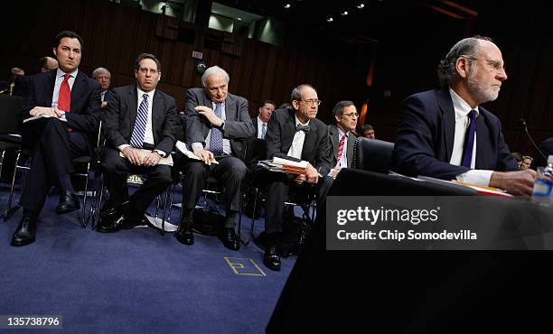 Group of lawyers sits behind former MF Global Chairman and CEO Jon Corzine and other former company executives as they testifiy before the Senate...