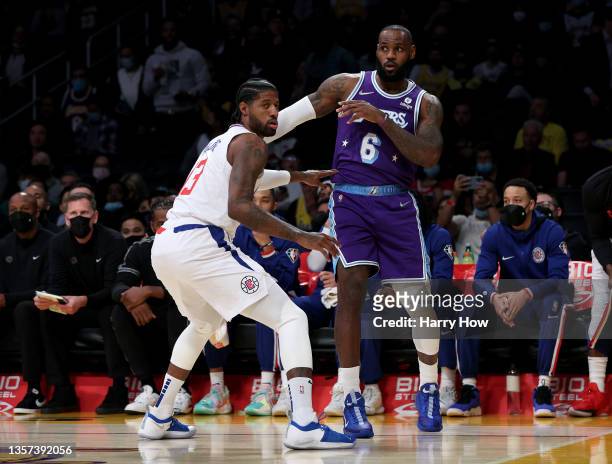 LeBron James of the Los Angeles Lakers and Paul George of the LA Clippers react to a pass during a 119-115 Clippers win over Lakers at Staples Center...