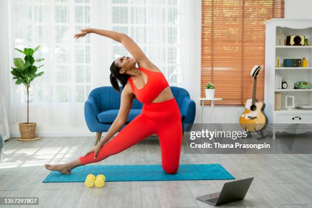 woman doing yoga video in home. - exercise computer stock pictures, royalty-free photos & images