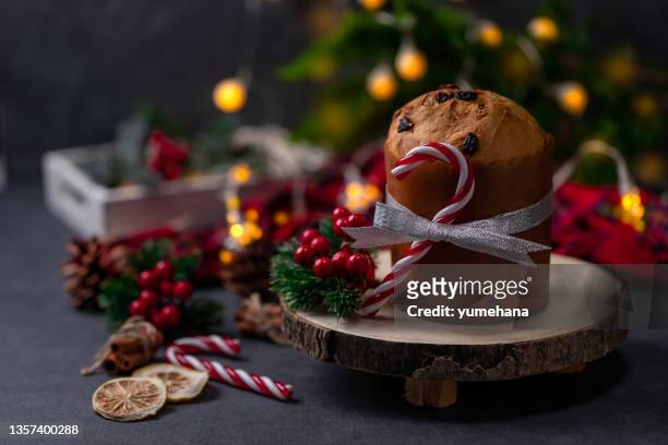 traditional christmas panettone cake with dried fruits on dark stone background - panettone stock pictures, royalty-free photos & images