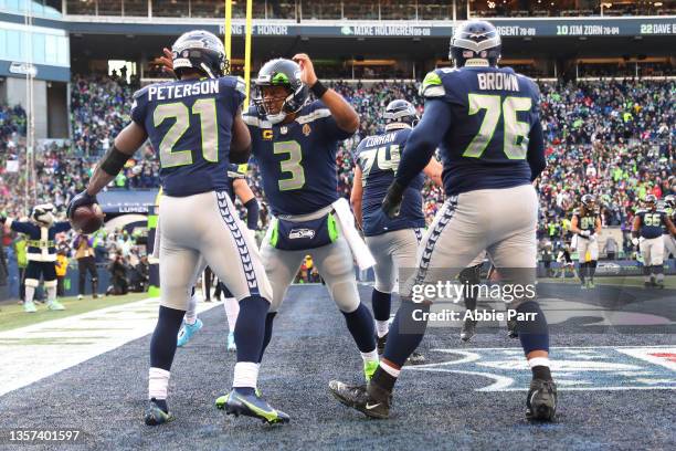 Adrian Peterson of the Seattle Seahawks celebrates his touchdown with Russell Wilson during the second quarter against the San Francisco 49ers at...