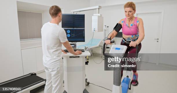 woman taking a cardiopulmonary stress test in clinic - stress test stock pictures, royalty-free photos & images