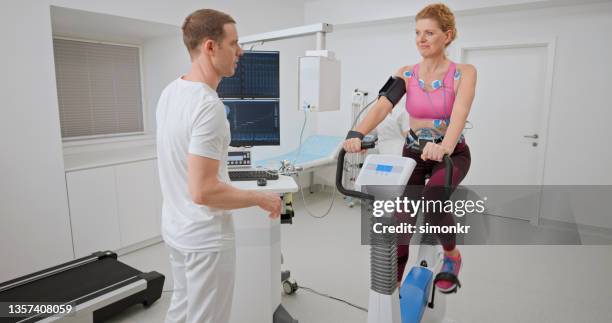 woman taking a cardiopulmonary stress test in clinic - cardiopulmonary system stock pictures, royalty-free photos & images