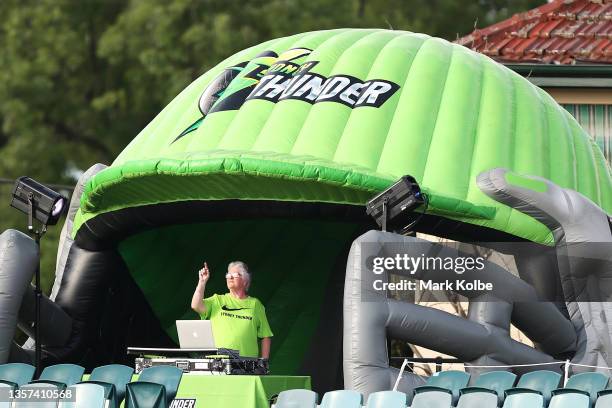 The DJ plays music during the warm-up before the Men's Big Bash League match between the Sydney Thunder and the Brisbane Heat at Manuka Oval, on...